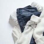 Black Framed Eyeglasses On White Jacket And Blue Denim Bottoms